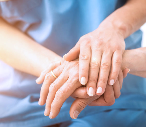 Nurse Holding Patient's Hand